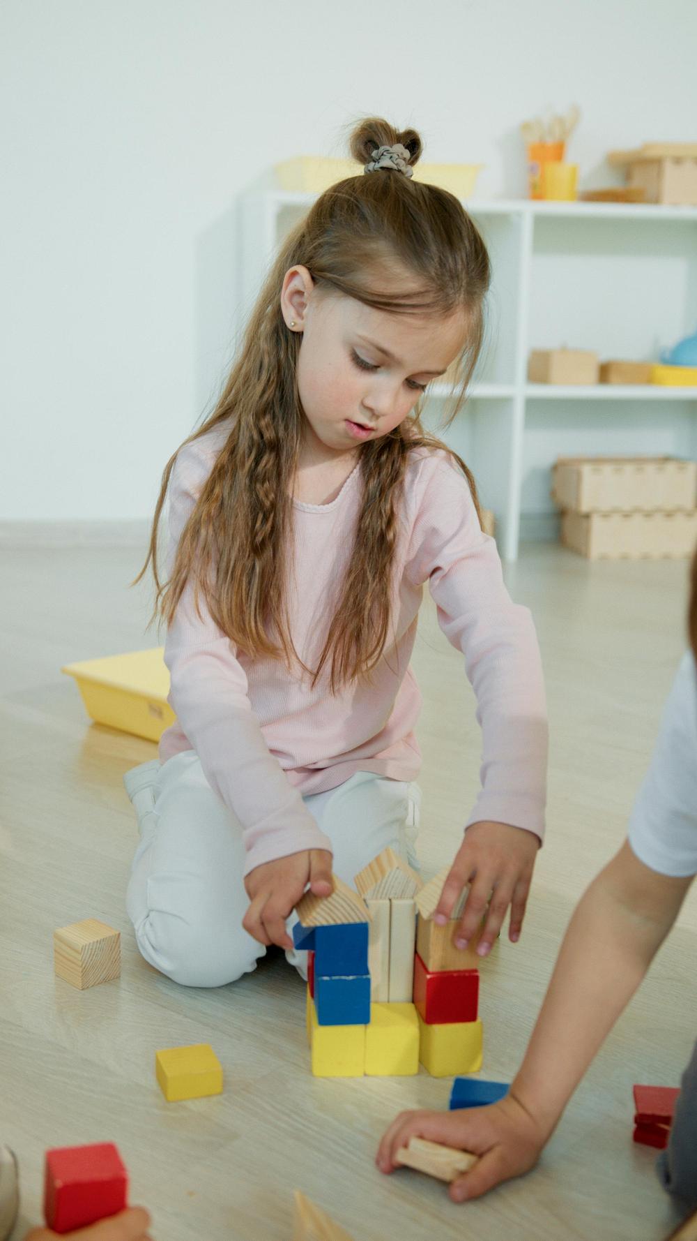 A child building with colorful blocks during play therapy